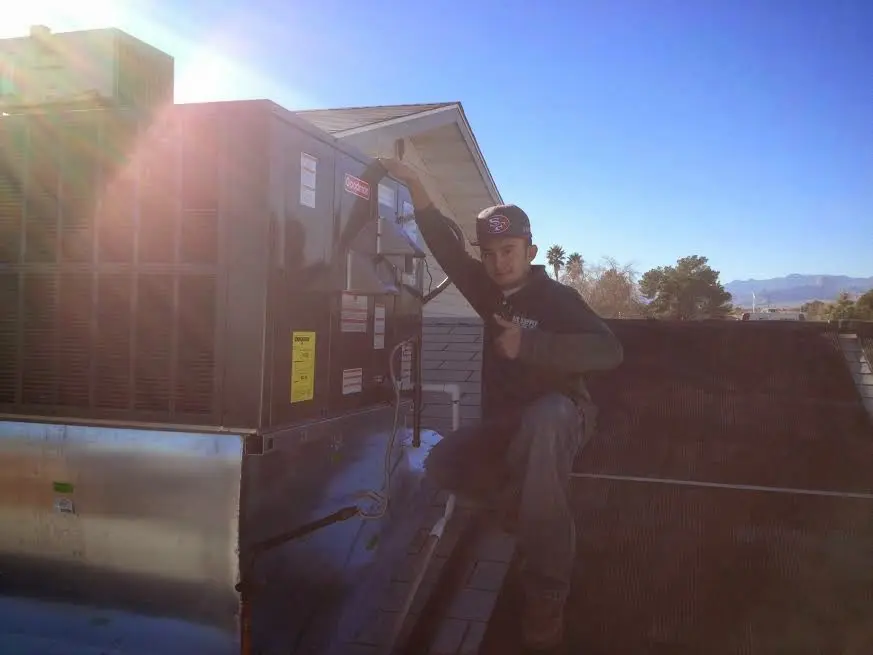 HVAC technician performing AC Tune-Up on a rooftop unit in Balm